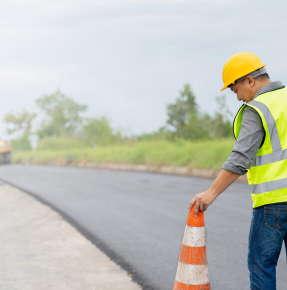 Safety-conscious construction worker walking on a road